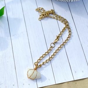 White aragonite polished stone with gold plated chain
